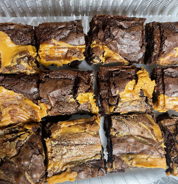 Our Chocolate Peanut Brownie is our signature brownie filled with Reese cups and topped with peanut butter. This Chocolate Peanut Butter Brownie is Heaven sent.